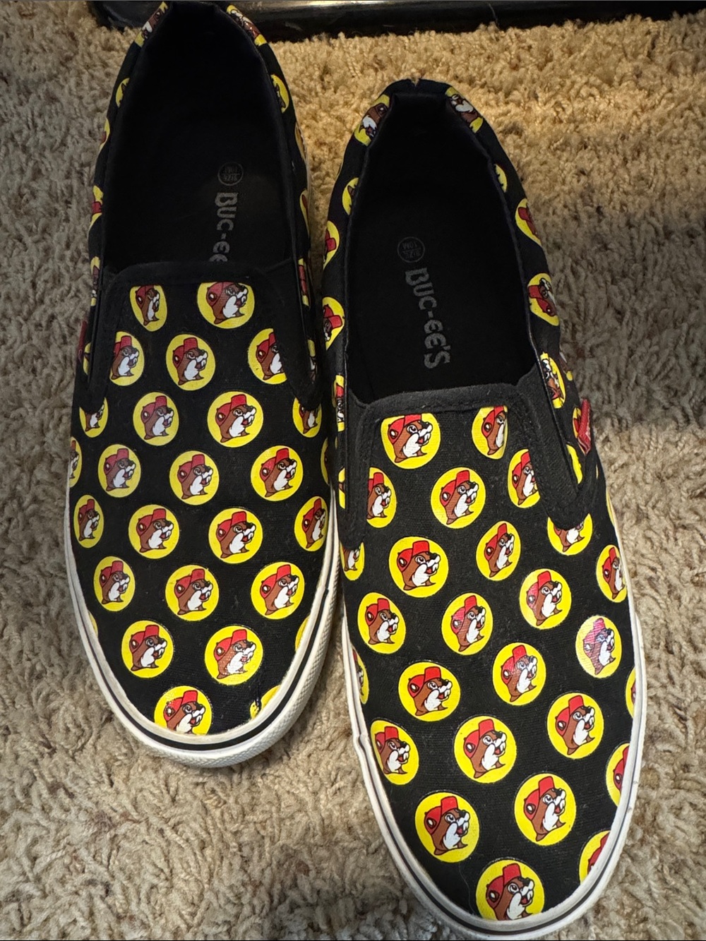 Ladies Buc-ee’s Black Slip-On Shoes with Yellow Logo Print